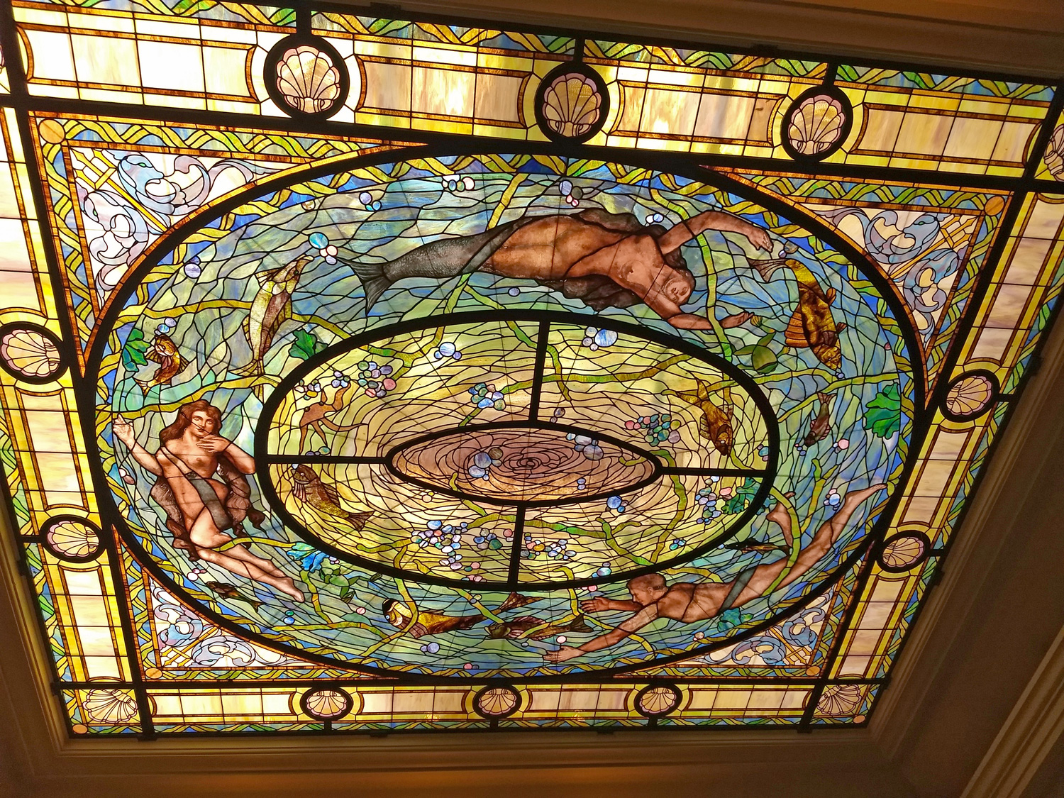 Colorful stained glass ceiling with mermaids, mermen